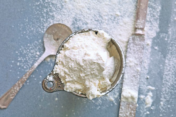 Vintage Flour Measuring cup with Flour, Spoon and knife for leveling.