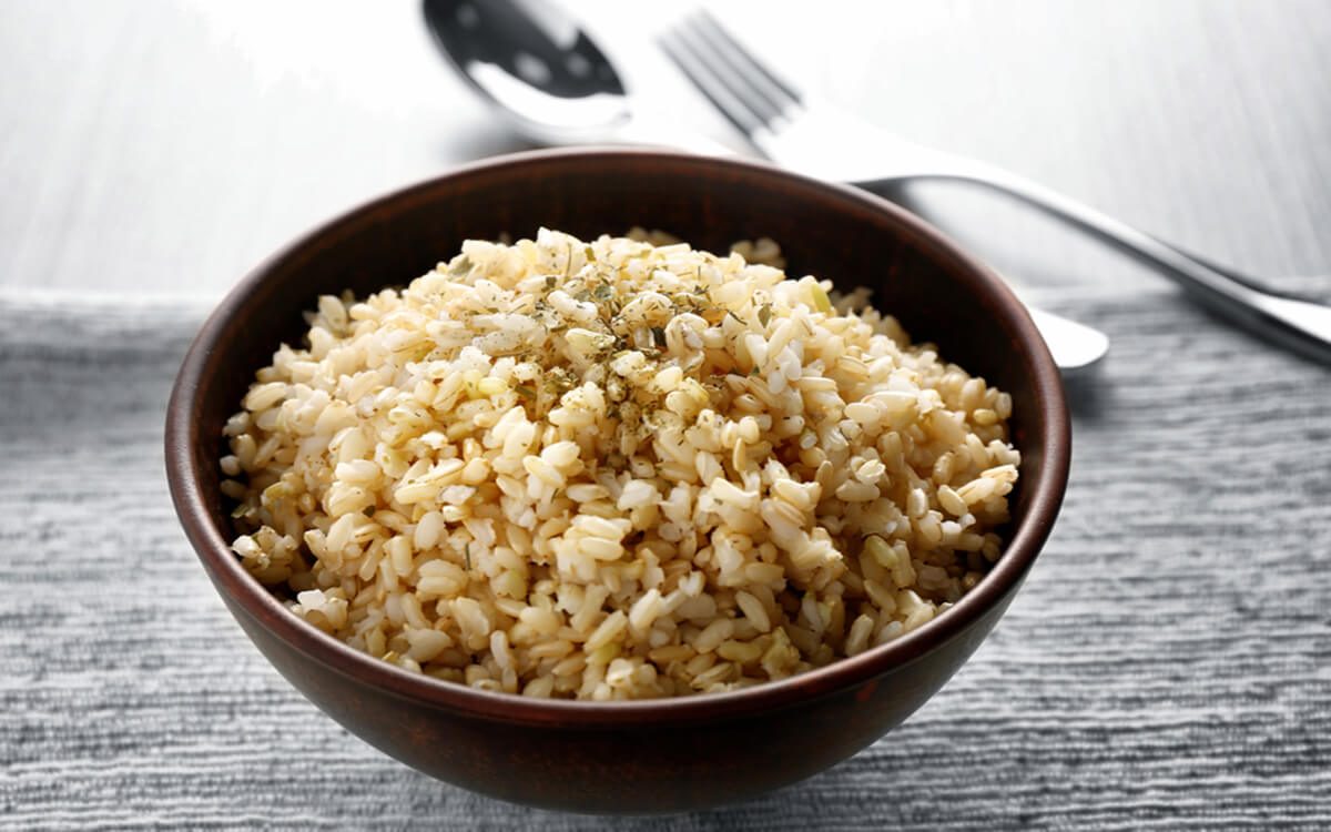 Bowl full of brown rice on napkin