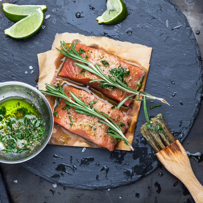 Fish filets dripping with marinade