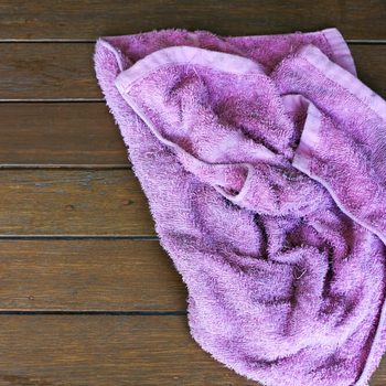 purple rag isolate on wooden background