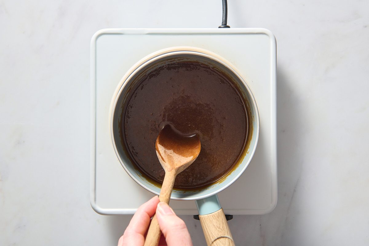 Butterscotch sauce ingredients being boiled and stirred