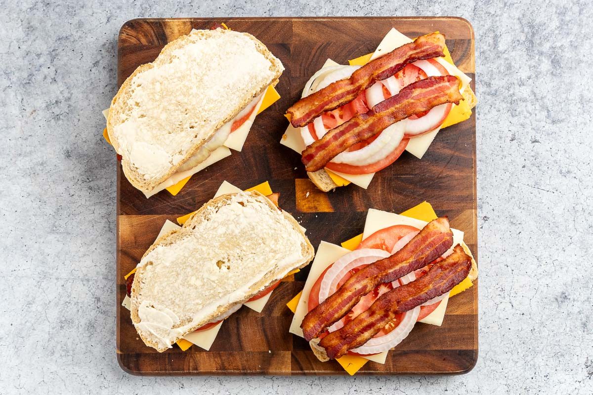  layering the ingredients to make the sandwiches.