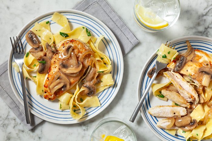 An overhead shot captures a delicious plate of chicken topped with a creamy mushroom sauce.