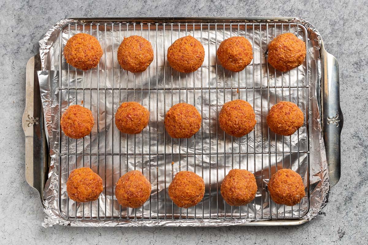 formed meatballs baked on a rack.