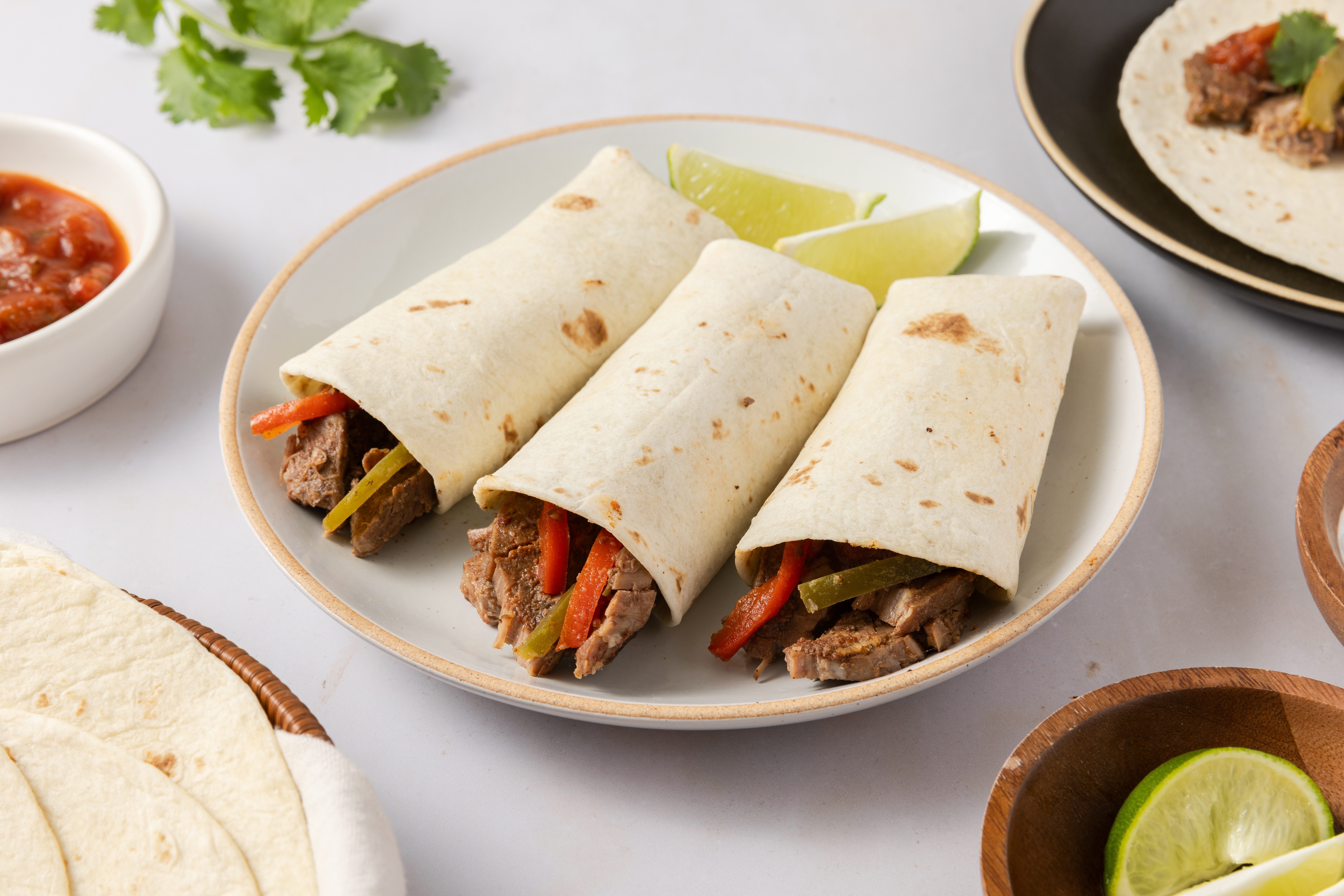 Fajitas rolled and ready served on plate.