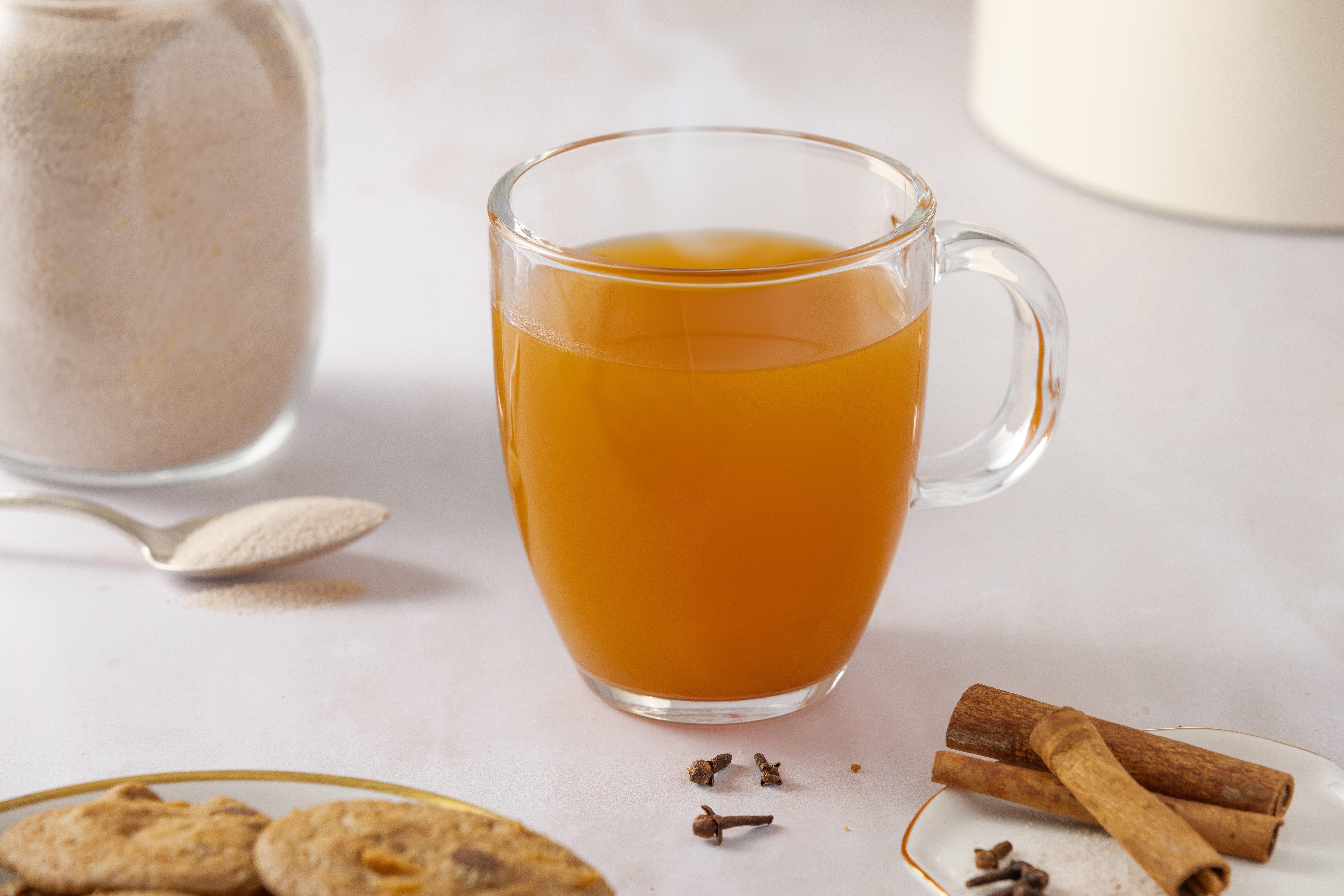 Spiced tea drink served in glass mug.