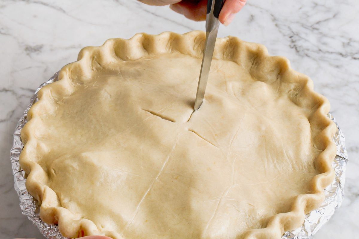 Cutting four one-inch slits in the top of the pie